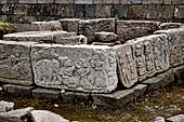 Candi Cetho - bas reliefs panels of the ninth terrace. The prince and his attendant kneeling and paying their respect to a deity. Behind are depicted a bull and an elephant. 